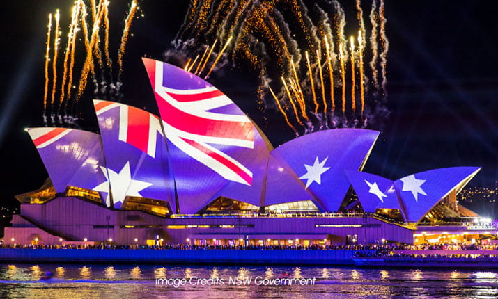 The Opera House sails lit up with vibrant colours on Australia Day.